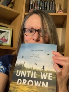 Author selfie with an advance proof copy of Until We Drown